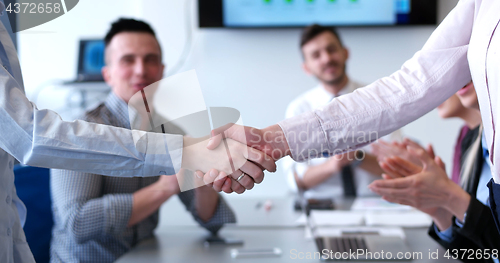 Image of cloasing the deal in modern office interior