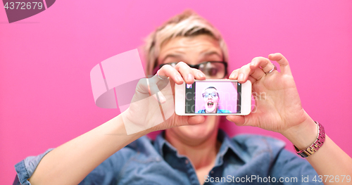 Image of woman taking selfie in startup office