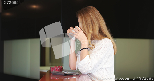 Image of Blonde drinking coffee enjoying relaxing lifestyle