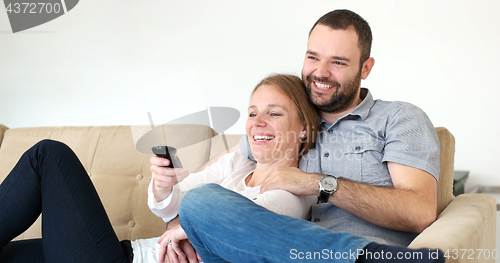 Image of senoior couple watching tv in modern villa