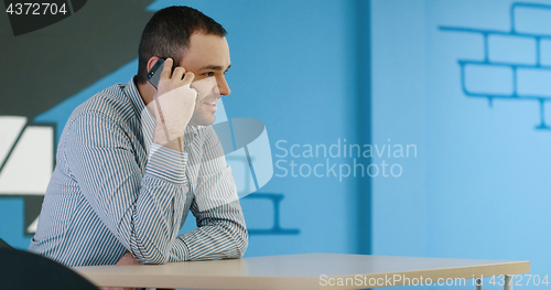 Image of Senior businessman  using cell phone at  stratup office