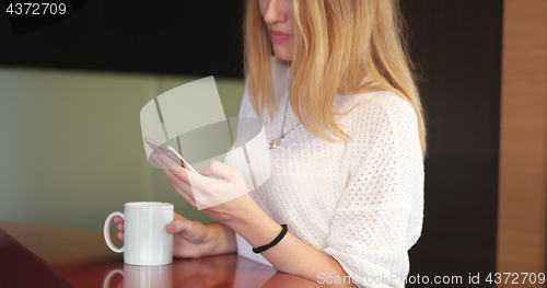 Image of Blonde drinking coffee enjoying relaxing lifestyle