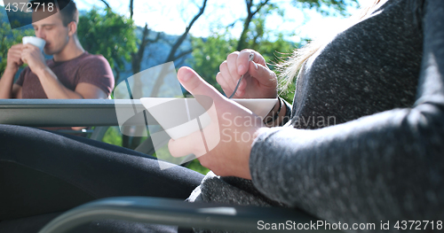 Image of Happy Couple Drinking Coffee and eating breakfast on terrace of 