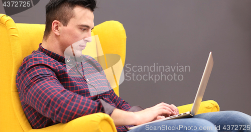 Image of businessman working using a laptop in startup office