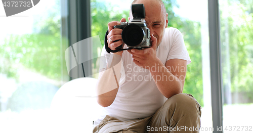 Image of Photographer takes pictures with DSLR camera