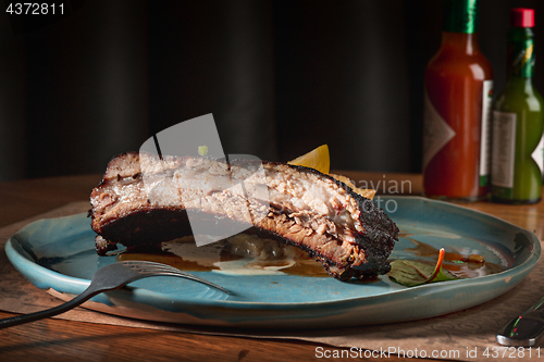 Image of grilled pork ribs on dark plate