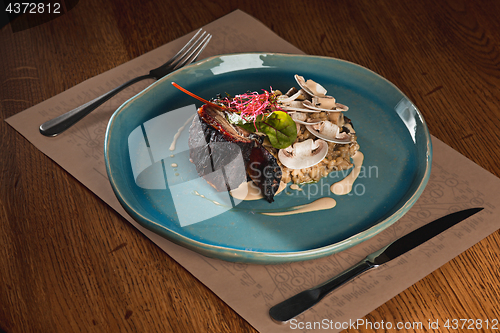 Image of grilled pork ribs on dark plate