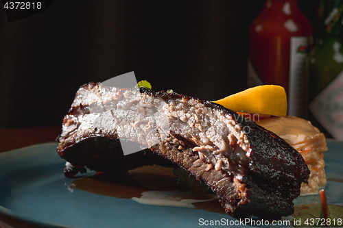 Image of grilled pork ribs on dark plate