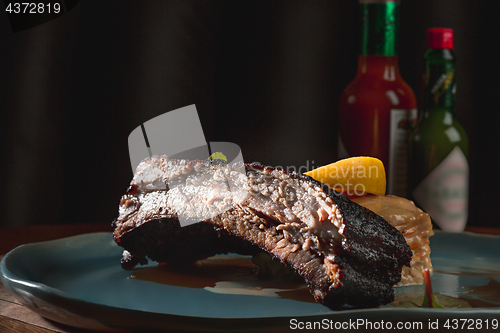 Image of grilled pork ribs on dark plate