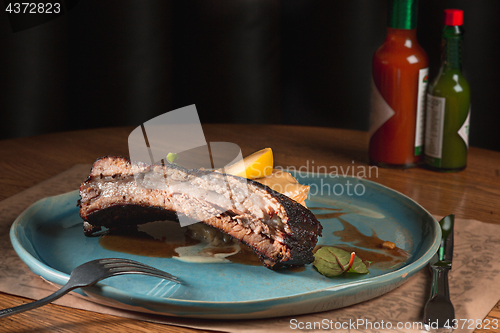 Image of grilled pork ribs on dark plate