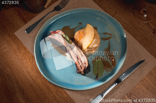 Image of grilled pork ribs on dark plate