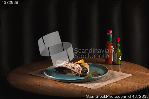 Image of grilled pork ribs on dark plate