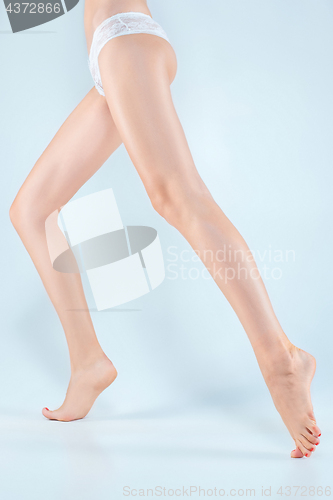 Image of Perfect female legs in underwear.