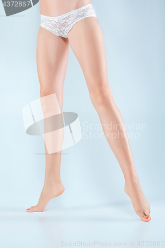 Image of Perfect female legs in underwear.