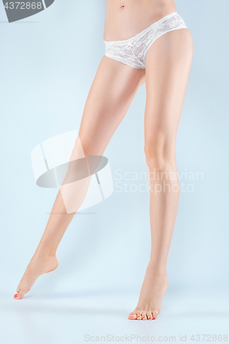 Image of Perfect female legs in underwear.