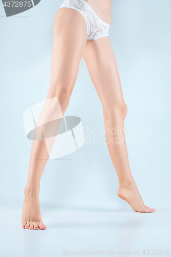 Image of Perfect female legs in underwear.