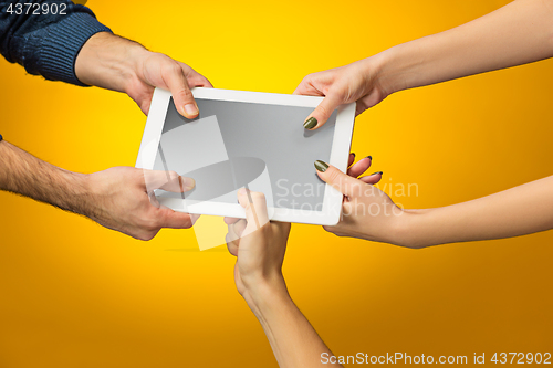 Image of female teen hands using tablet pc with black screen, isolated