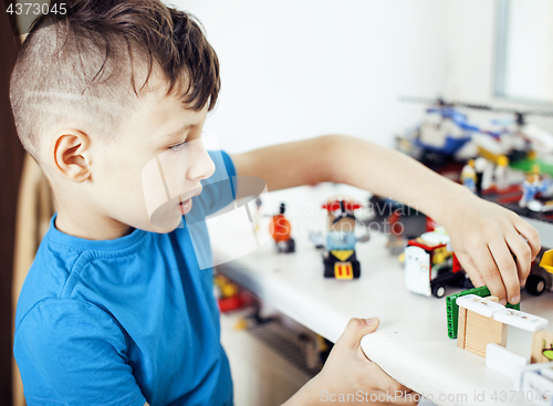 Image of little cute preschooler boy playing toys at home happy smiling, lifestyle children concept