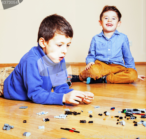 Image of funny cute children playing toys at home, boys and girl smiling,