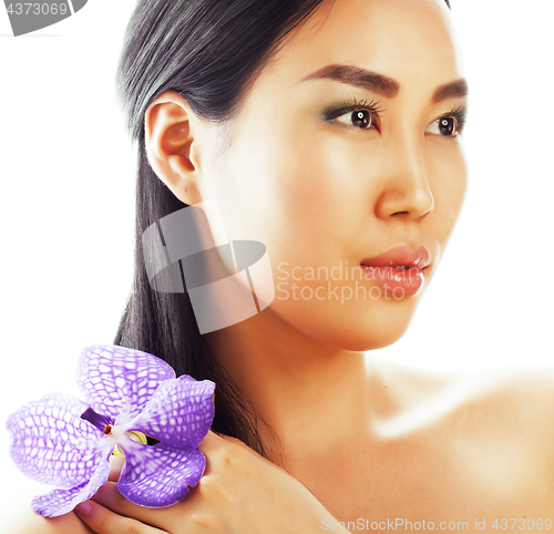 Image of young pretty asian woman with flower purple orchid close up isolated spa, womans day concept