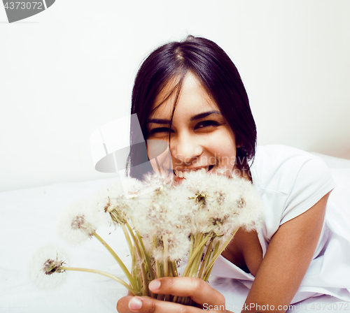 Image of young happy smiling latin american teenage girl emotional posing on white background, lifestyle people concept , holding dandelion flowers