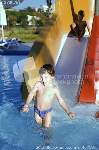 Image of little cute real boy in swimming pool close up smiling, lifestyle vacation people concept