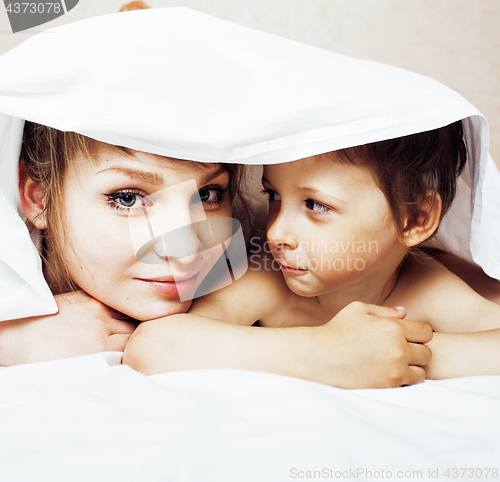 Image of young blond woman with little boy in bed, mother and son, happy familyyoung blond woman with little boy in bed, mother and son, happy family 