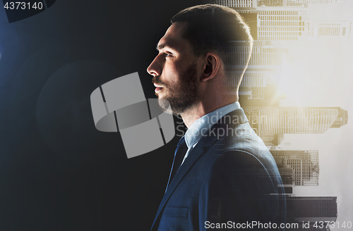 Image of businessman over city buildings