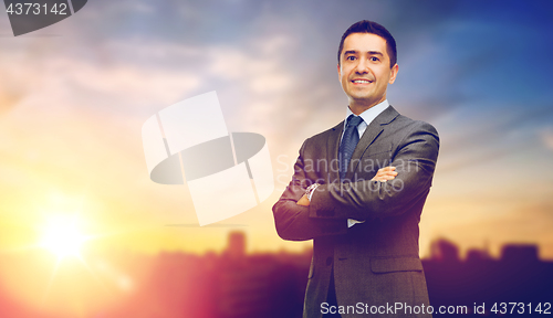 Image of happy smiling businessman over city background