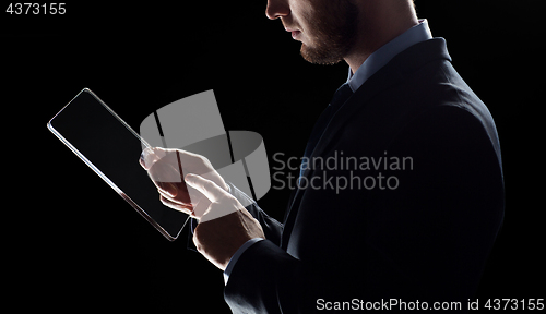 Image of close up of businessman with transparent tablet pc