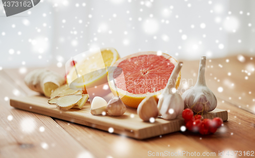 Image of citrus, ginger, garlic and rowanberry on wood