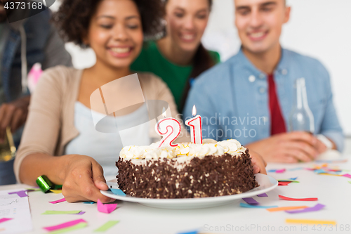 Image of team greeting coworker at office birthday party