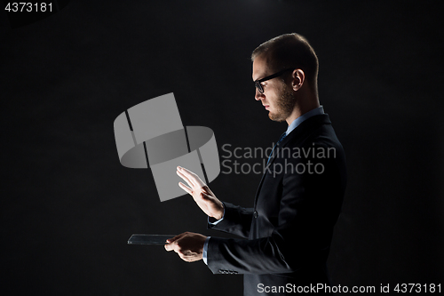Image of close up of businessman with transparent tablet pc
