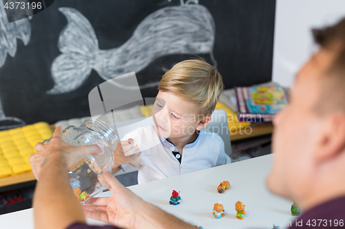 Image of Cute little toddler boy at speechtherapist session.