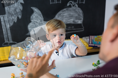 Image of Cute little toddler boy at speechtherapist session.