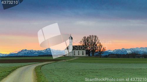 Image of Morning Alpine landscape with sunrise over St. Andreas chapel