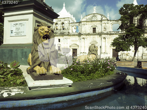 Image of lion statues Parque Central with Cathedral Leon in background Ni