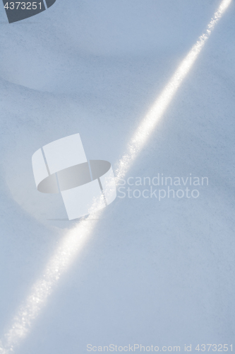 Image of sun ray on snow surface