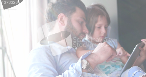 Image of Father Daughter using Tablet in modern apartment