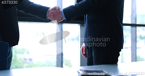 Image of cloasing the deal in modern office interior