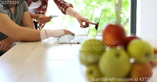 Image of Couple Using Laptop To Shop Online in modern apartment