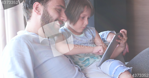 Image of Father Daughter using Tablet in modern apartment