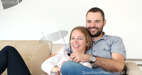 Image of senoior couple watching tv in modern villa