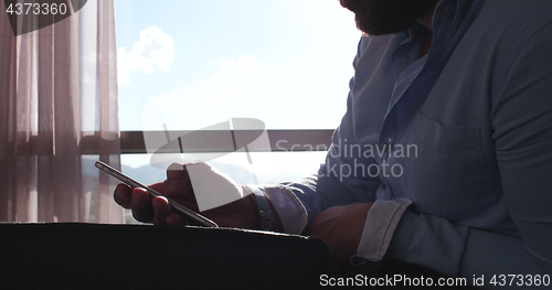 Image of Business Man Talking On Cell Phone At Home