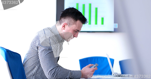 Image of Senior businessman  using cell phone at  stratup office