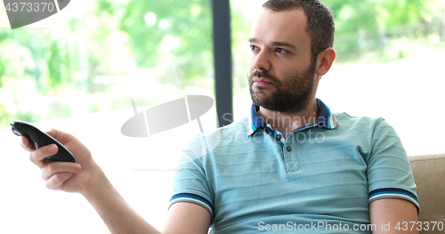 Image of Happy Man Watching Television