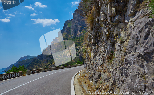 Image of Asphalt road. Colorful landscape with beautiful mountain road with a perfect asphalt. High rocks, blue sky at sunrise in summer. Vintage toning. Travel background. Highway at mountains