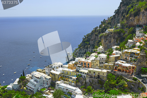 Image of One of the best resorts of Italy with old colorful villas on the steep slope, nice beach, numerous yachts and boats in harbor and medieval towers along the coast, Positano.