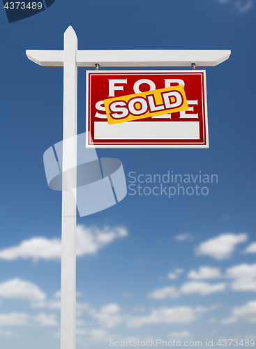 Image of Right Facing Sold For Sale Real Estate Sign on a Blue Sky with C