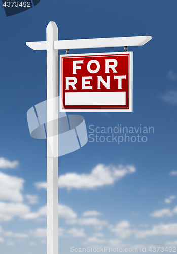 Image of Right Facing For Rent Real Estate Sign on a Blue Sky with Clouds